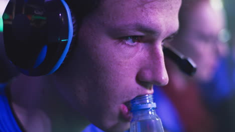 a gamer drinking water during a competition