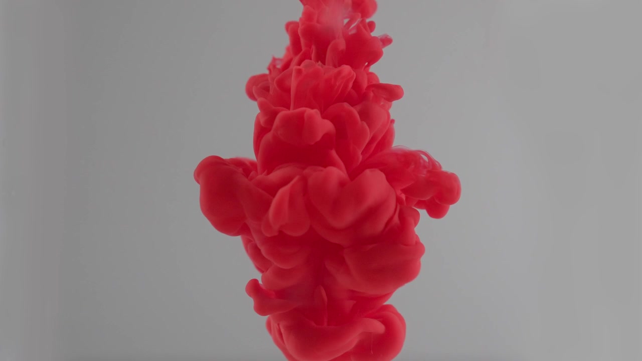 Vibrant Red Ink Cloud Diffusing in Clear Water