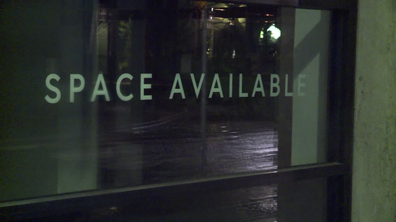 REAL ESTATE COMMERCIAL SPACE AVAILABLE SIGN AT NIGHT