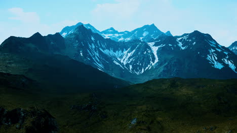 mountain gorge with green meadow illuminated by the sun