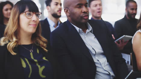 a group of businesspeople sitting in a conference