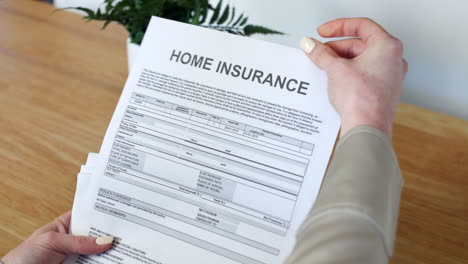 A-woman-opening-a-home-Insurance-Document-letter-outlining-her-policy-and-cover-details