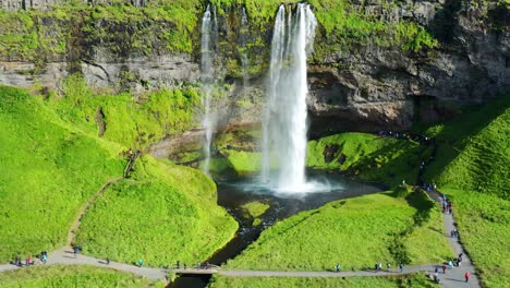 several tourists visited the famous seljalandsfoss waterfall in the south coast of iceland