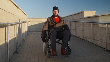 man in wheelchair on outdoor ramp