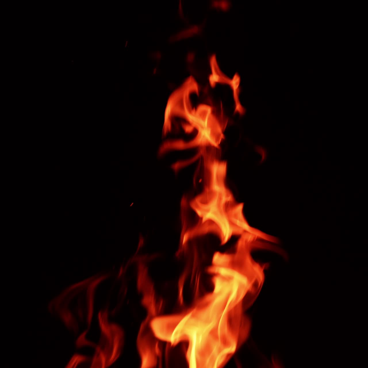 Top part of the bonfire burning at night. Hot dangerous flame isolated close up