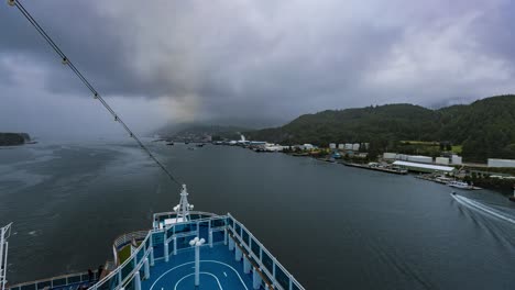 time lapse overlooking a back, stern ship deck, while pulling away from an alaskan port, in the rain