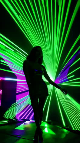 vibrant laser light show with silhouetted performer