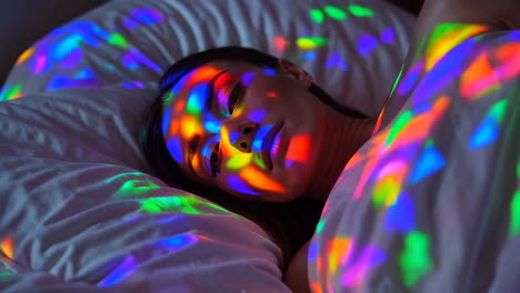 dreamlike portrait: woman illuminated by colorful light patterns