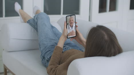 Woman-Using-Smartphone-to-Talk-to-His-Doctor-via-Video-Conference-Medical-App.-Person-Checks-Symptoms-Talks-with-Physician-Using-Online-Video-Chat-Application