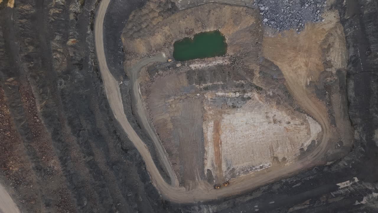 Drone footage showing the rugged landscape and pathways of Boral Quarry in Australia, showcasing layers of earth under natural light for industrial and environmental insights