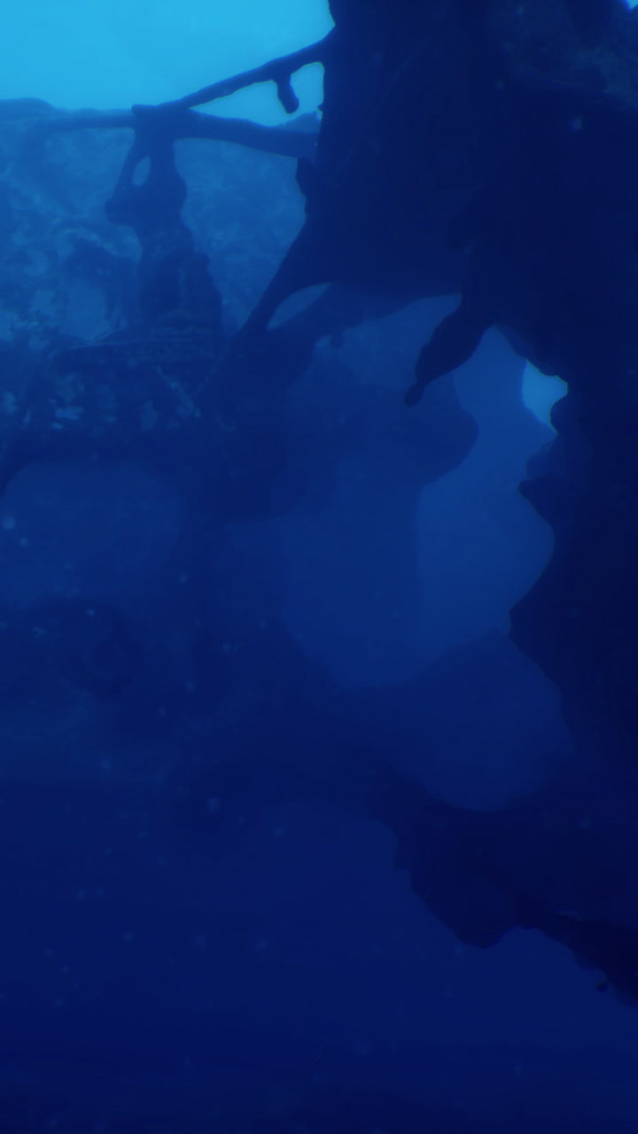 Underwater scene with sunken structure in dark blue water