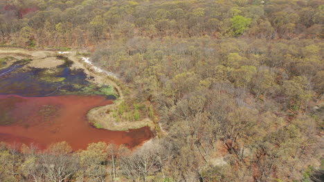 an aerial view of a orange colored lake during the day