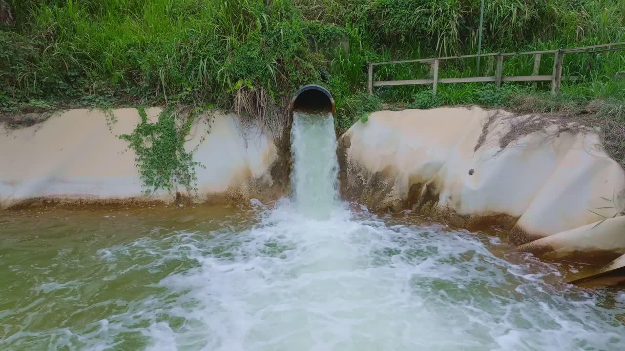 Barrick Gold mine's water purification facility, treatment ponds and system before water is released to local rivers, Cotui, Dominican Republic. Aerial drone approach, low flight over waters