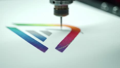 creative process of a high-tech precision tool artistically rendering colorful gradient design on paper using a specialized drawing pen