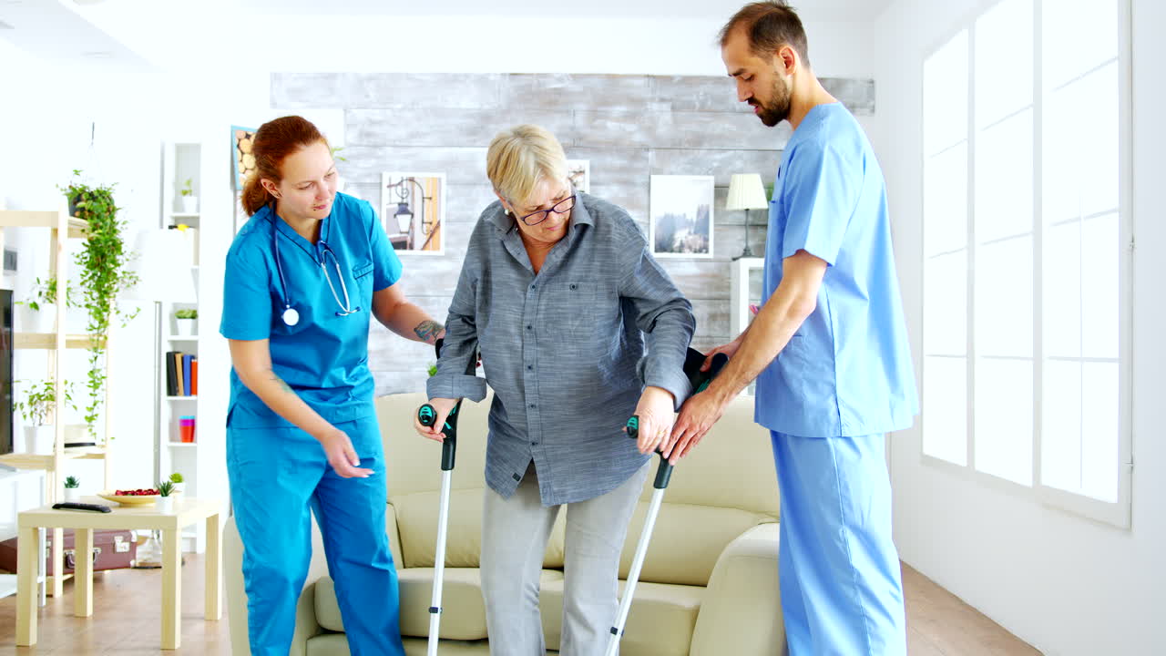 Senior woman with crutches getting help for female nurse