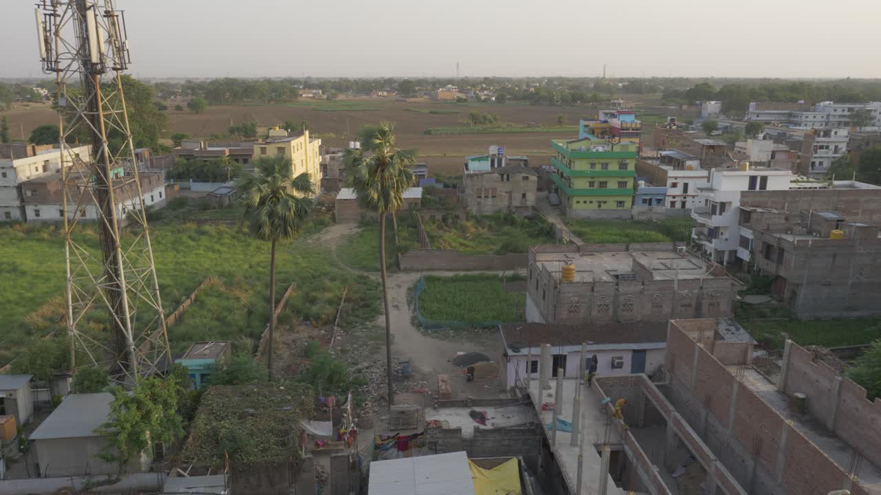 Rural India landscape, concrete buildings and farmland, High angle view