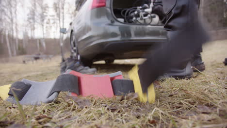 Ice-diver-drops-weight-belt-to-the-ground-behind-car-after-penetration-dive