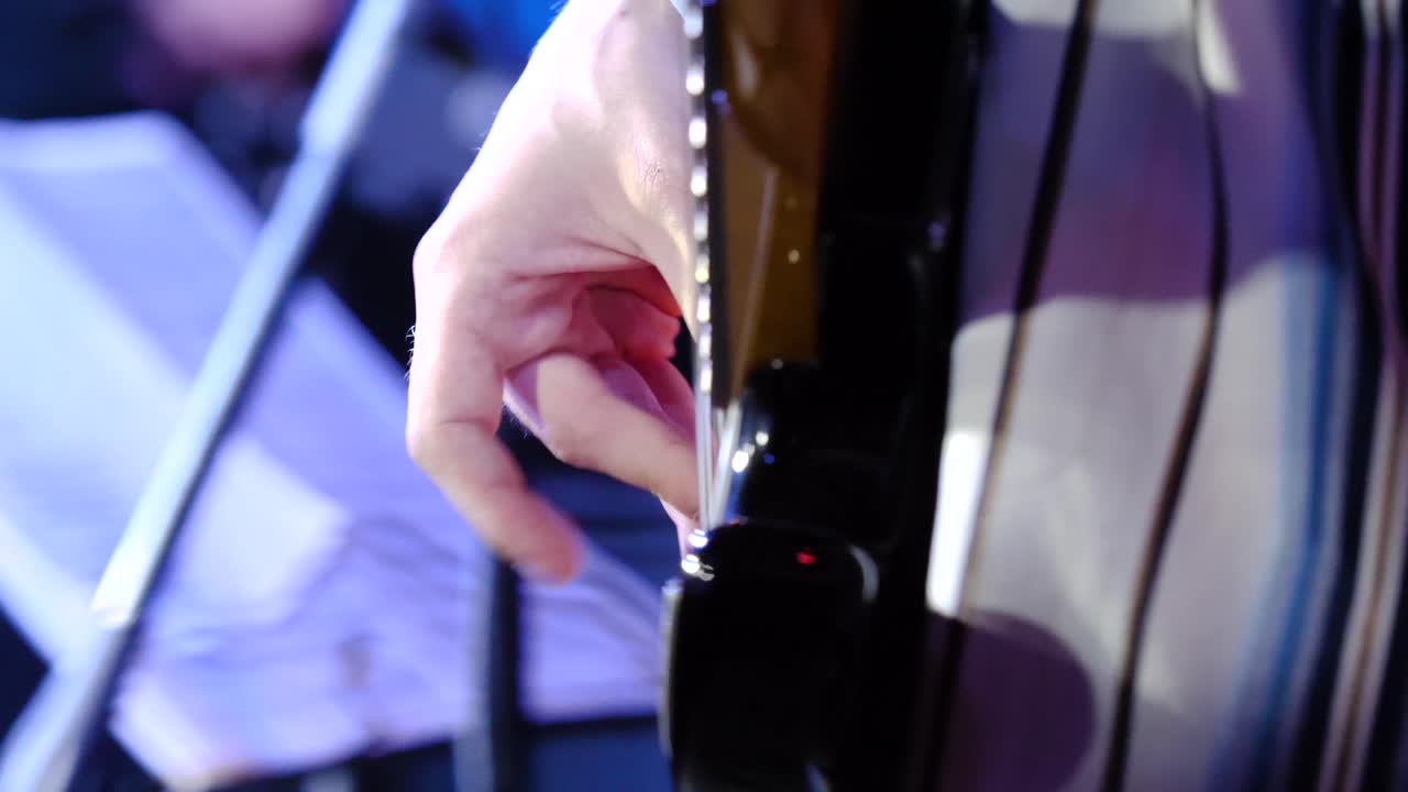 Closeup of a guitarist performing live on stage