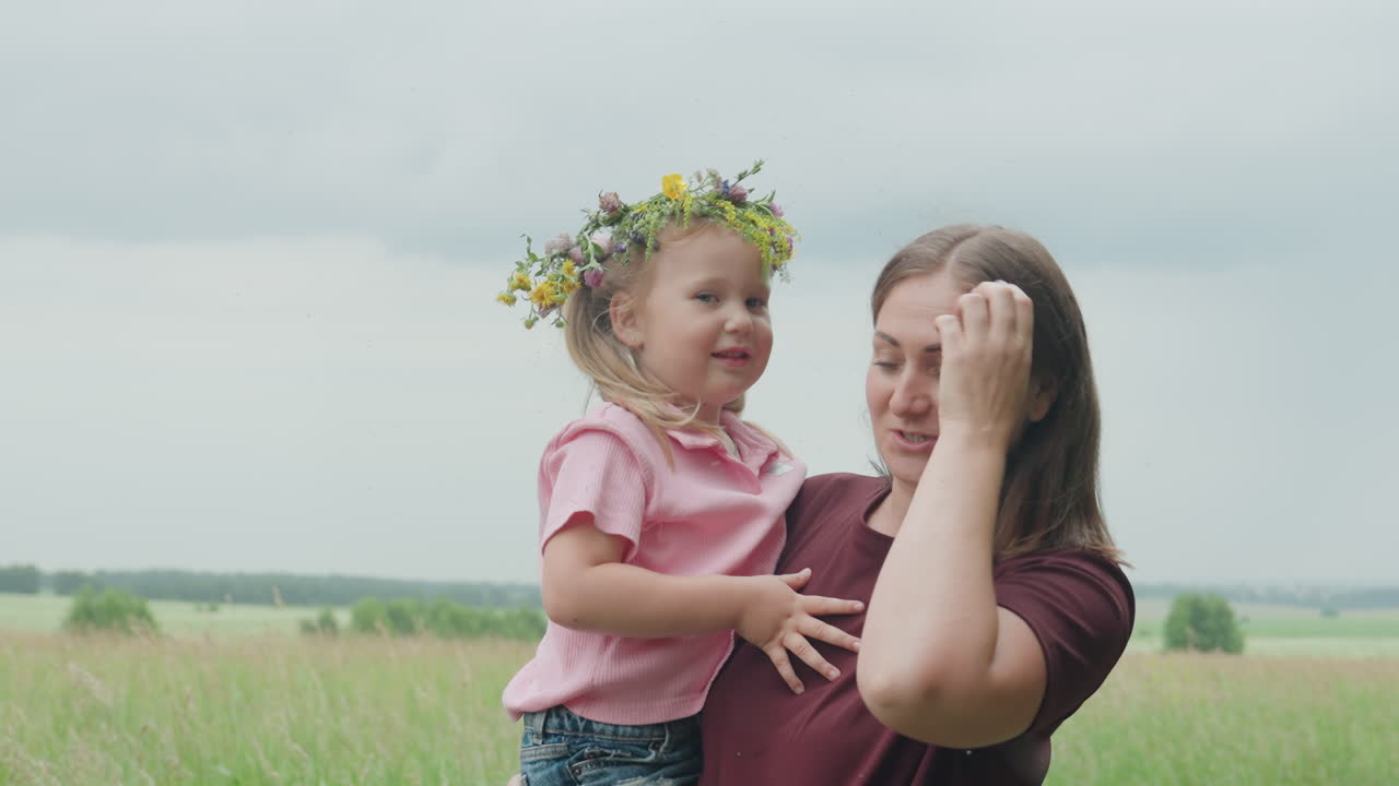 Gentle mother and daughter embrace outside, Peaceful moment of mother and daughter in nature, Tender familial connection depicted through mother and daughter surrounded by peaceful meadow