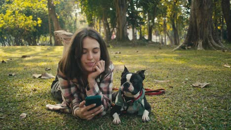 woman and dog relaxing in the park