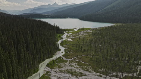 emerald lake bc canada aerial v3 cinematic drone flyover meandering river, water flows into the lake surrounded by lush coniferous forests and mountain valleys - shot with mavic 3 pro cine - july 2023