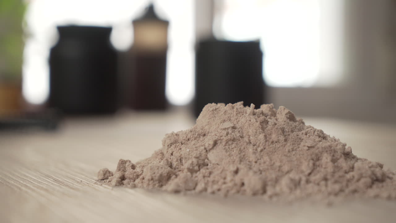 Hand crushing protein powder. Concept: protein bad for health