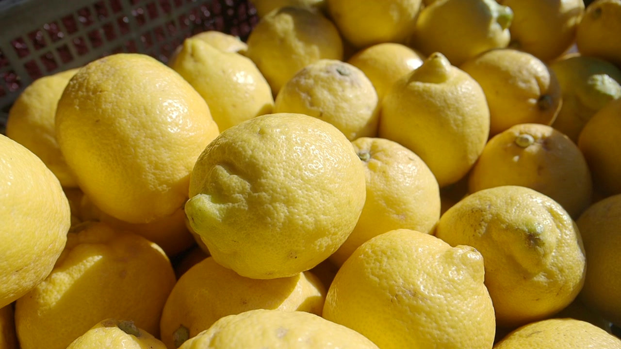 Close-Up View of Fresh Yellow Lemons in a Basket