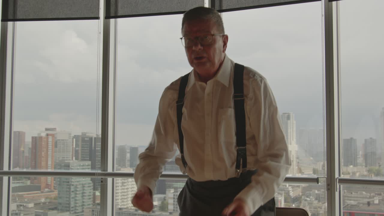 Older Businessman in Office with City View