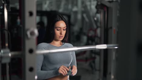 pretty-brunette-girl-puts-on-headphones-and-started-training