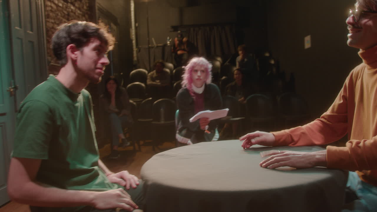 Actors Rehearsing on Stage with Female Theater Director