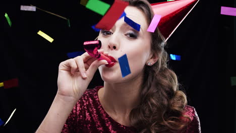 woman celebrating with party horn and confetti