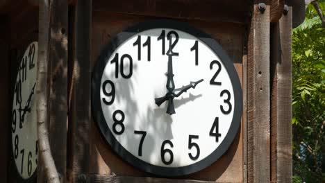 steady shot of white round clock mounted in a wooden crate, without a second hand