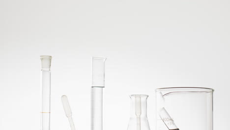 video of glass laboratory test tubes and dishes with copy space on white background