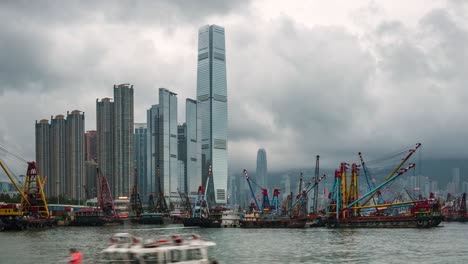 hong kong, china, timelapse view of modern skyscrapers and cargo ships at the port of hong kong, one of the busiest ports in the world