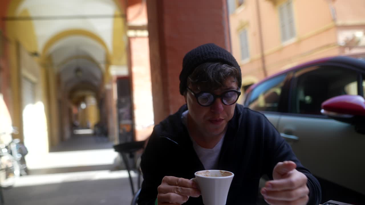 Person drinking coffee in an outdoor cafe in Italy