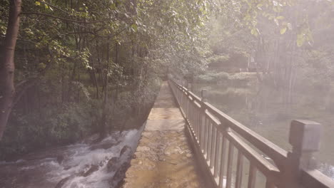 walking through mist over bridge of water source of diageo distillery in yunnan, china