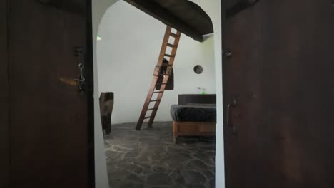 walking inside the rustic cob house design interior. holiday accommodation. pov shot
