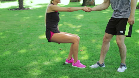 Sport-couple-resting-in-summer-park-after-workout-training.-Young-man