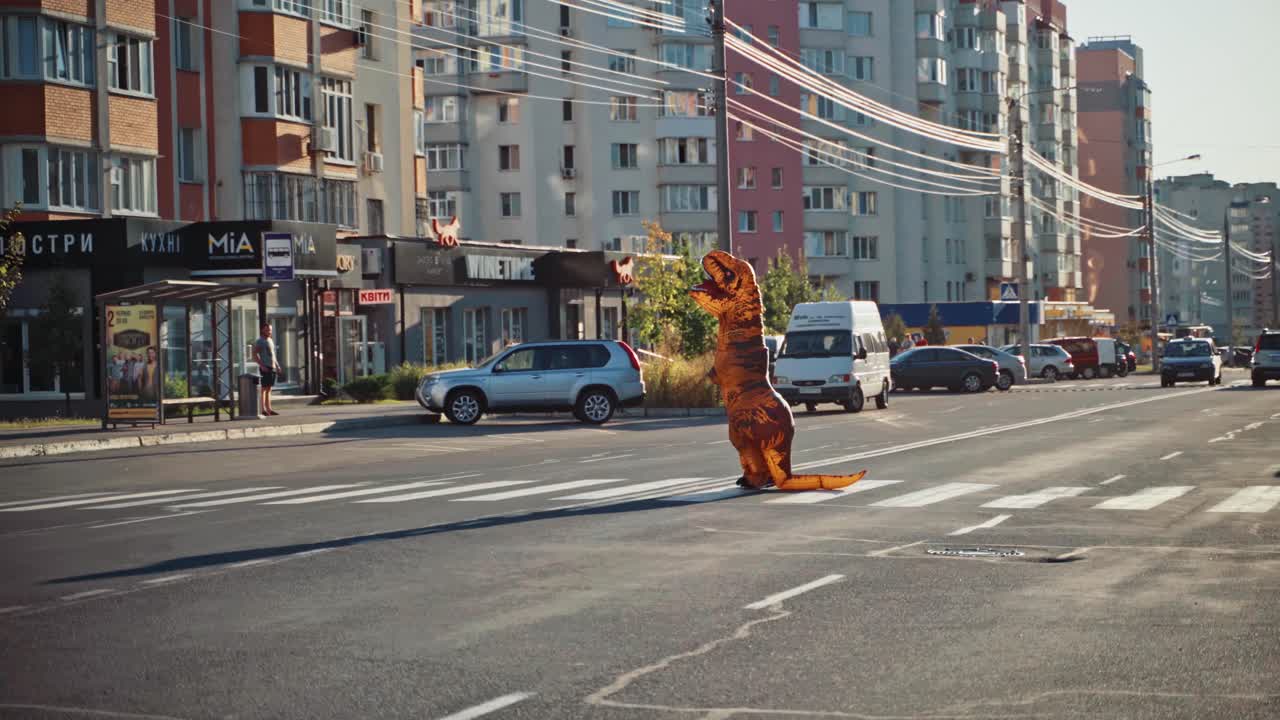 Funny man in t rex costume. Man in dino mascot at city street crosswalk