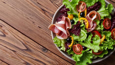 fresh salad with prosciutto and vegetables