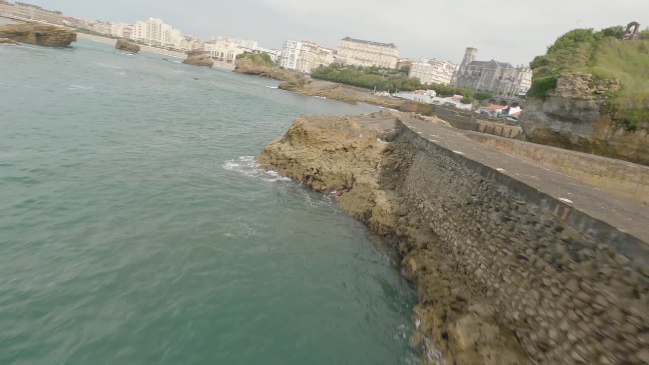 Drone flying over rocky pier of Cloche du Plateau de l'Atalaye, Biarritz, Pyrenees Atlantiques, French Basque Country