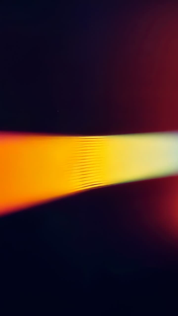 Vertical video: Loop starting beam cycling colors and pulsing on dark screen for animation