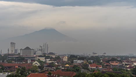panoramic view of a city with a mountain in the background under an overcast sky