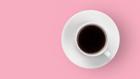 white coffee cup with hot espresso animated on a pastel pink background top view. seamless looping of realistic 3d food and drink. minimal motion design art with copy space