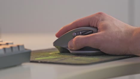 a gamer uses his gaming mouse to navigate through a dungeon in a computer-based video game