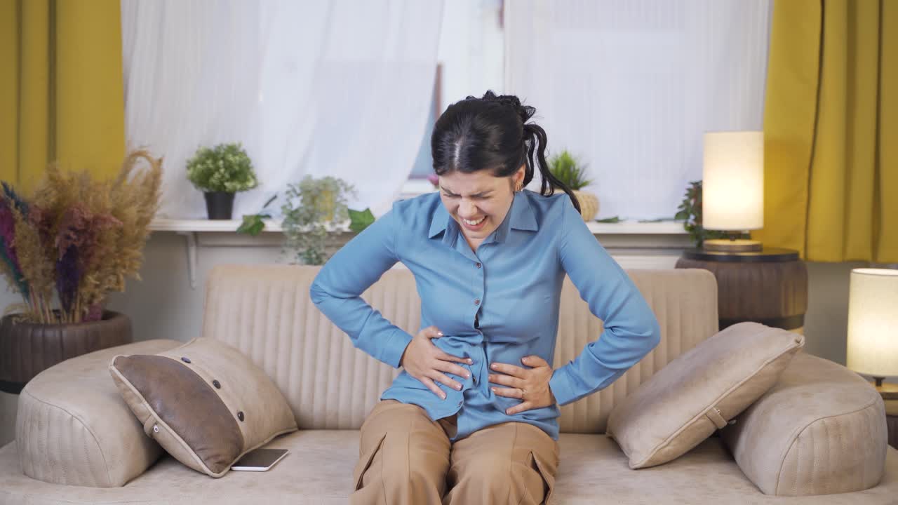 Young woman with stomachache.