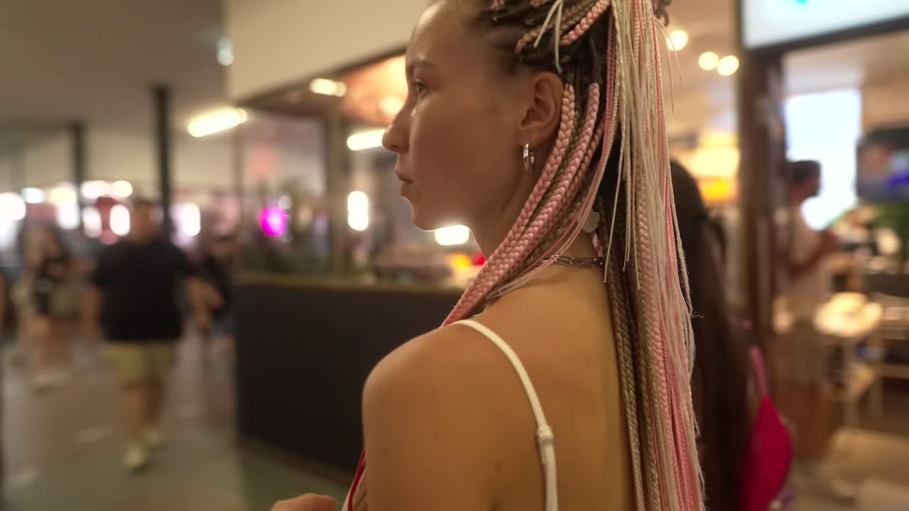 Donna con trecce rosa e bionde.