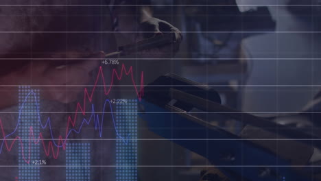 industrial technician scanning forklift controls in warehouse, displaying red and blue line graphs