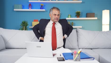 home office worker man has lower back pain.