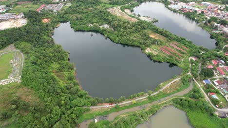 Aerial-circling-over-lake-at-Serendah-outskirts,-Selangor,-Malaysia